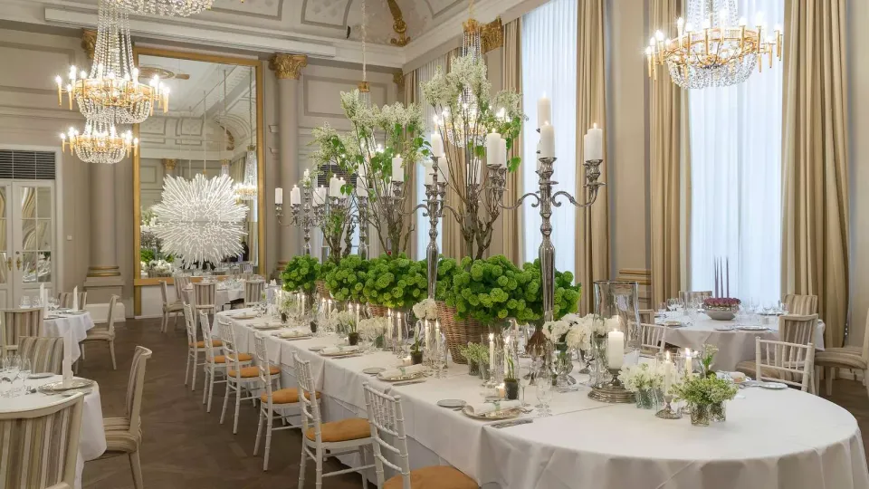 Hotel d’Angleterres festlokale med opdækkede langborde og lysekroner.