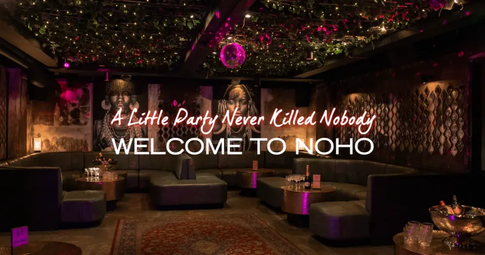 NOHOs interiør med sofaer, lave borde og diskokugle samt stedets originale tekstoverlejring “WELCOME TO NOHO”.