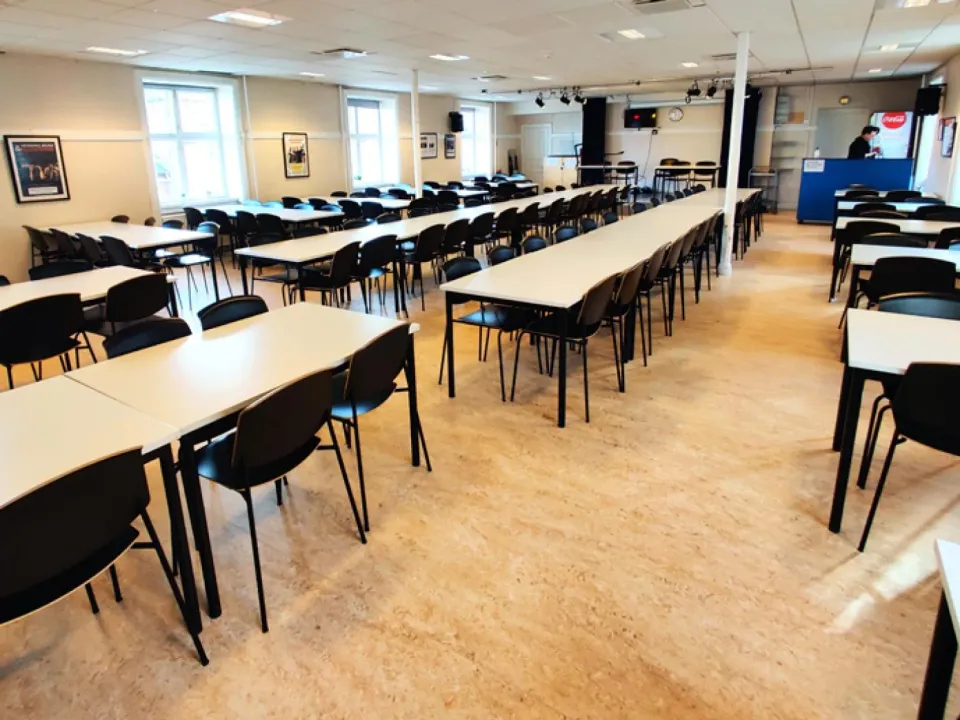 Salen på Loftet i Amager Kulturpunkt med langborde og stole.